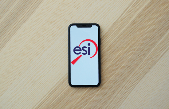 Cell phone on desk with ESI Logo.
